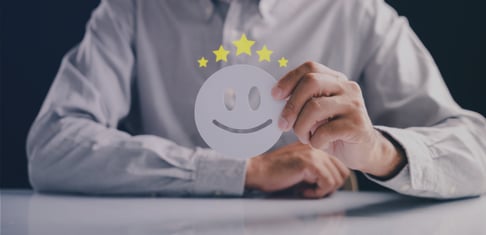 picture of a hand holding a happy face representing happy customers