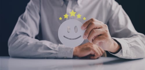 picture of a hand holding a happy face representing happy customers